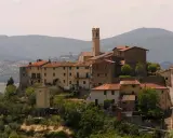 Borgo toscano con campanile, un luogo da film, dove la storia incontra la bellezza paesaggistica.