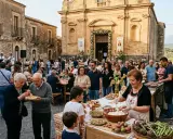 Festa di paese con musica e bancarelle di cibo, un'atmosfera vivace che ricorda le sagre autunnali.