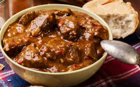 Un invitante stracotto toscano in una ciotola, pronto per essere gustato con pane fresco.