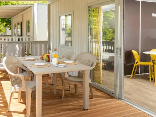 Tavolo apparecchiato su un patio in legno, ideale per chi cerca hotel che accettano cani in Toscana.