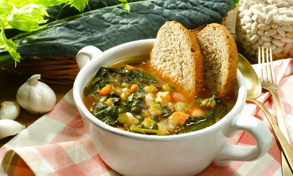 Zuppa di cavolo nero e fagioli, uno dei piatti tipici toscani, servita con pane tostato.