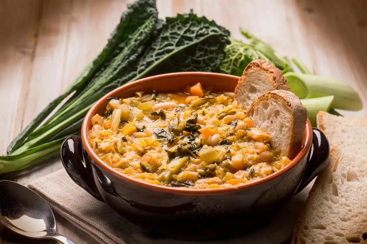 Zuppa toscana ricca di verdure e fagioli, perfetta da gustare con pane casereccio. Un classico su cosa mangiare in Toscana.
